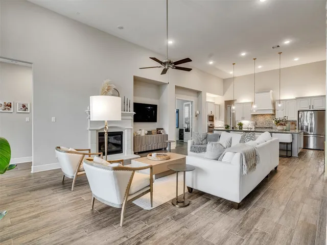 a living room with furniture a fireplace and a flat screen tv