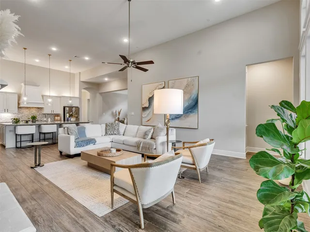 a living room with furniture and a potted plant