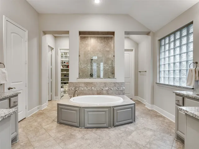 a spacious bathroom with sink shower and bathtub