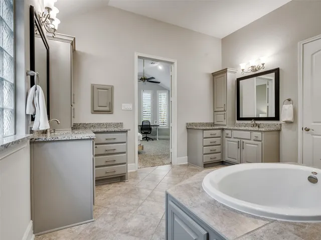 a bathroom with a sink a vanity and mirror