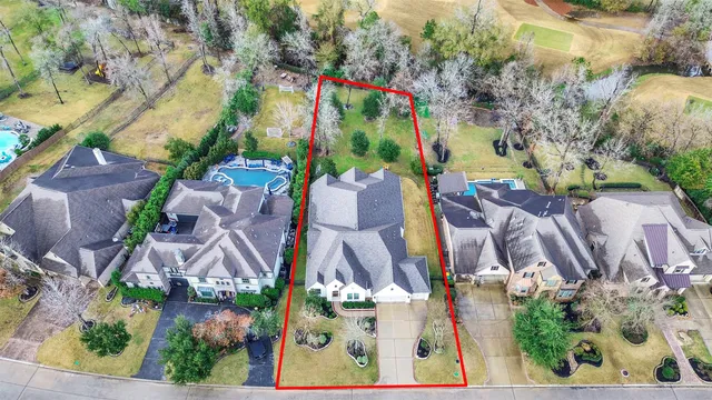 an aerial view of residential house with outdoor space and swimming pool