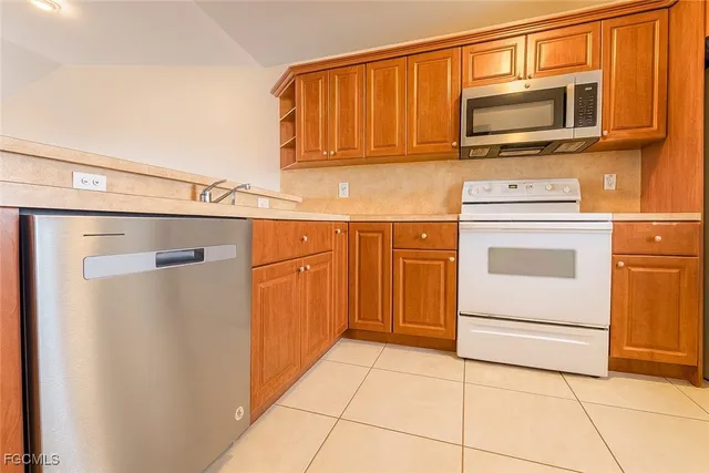 a kitchen with a stove top oven and cabinets