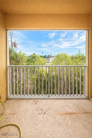 a view of a balcony with a yard