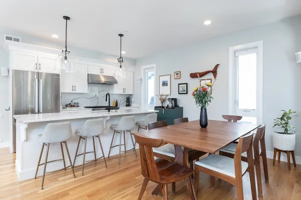 a view of kitchen with refrigerator dining table and chairs
