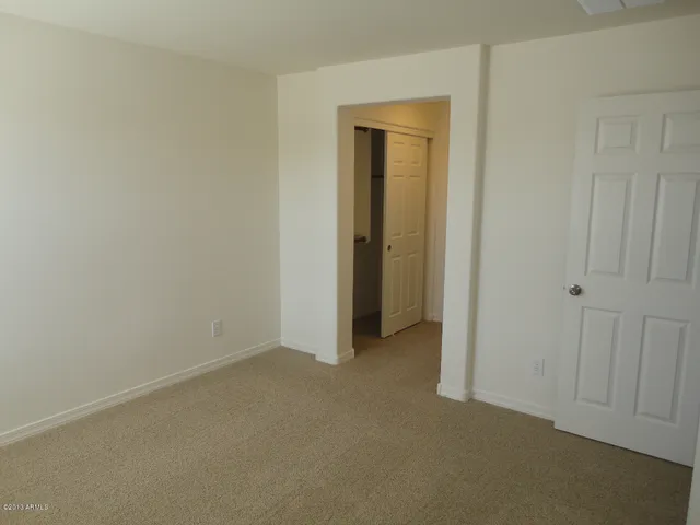 a view of an empty room and closet area