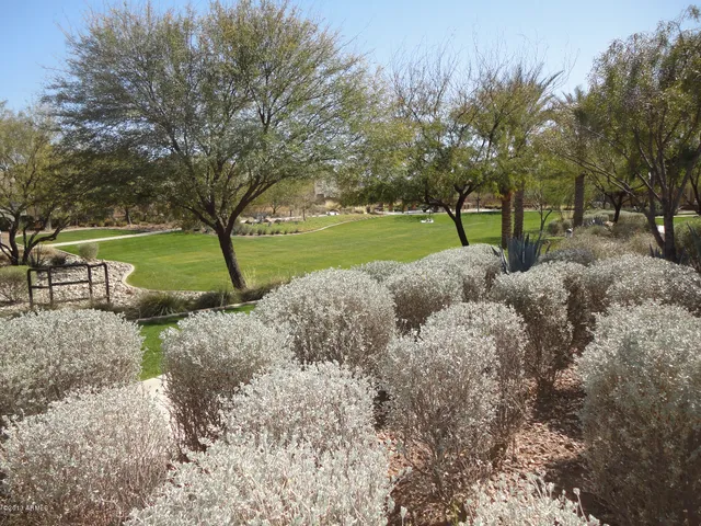 a view of a wooden fence next to a yard