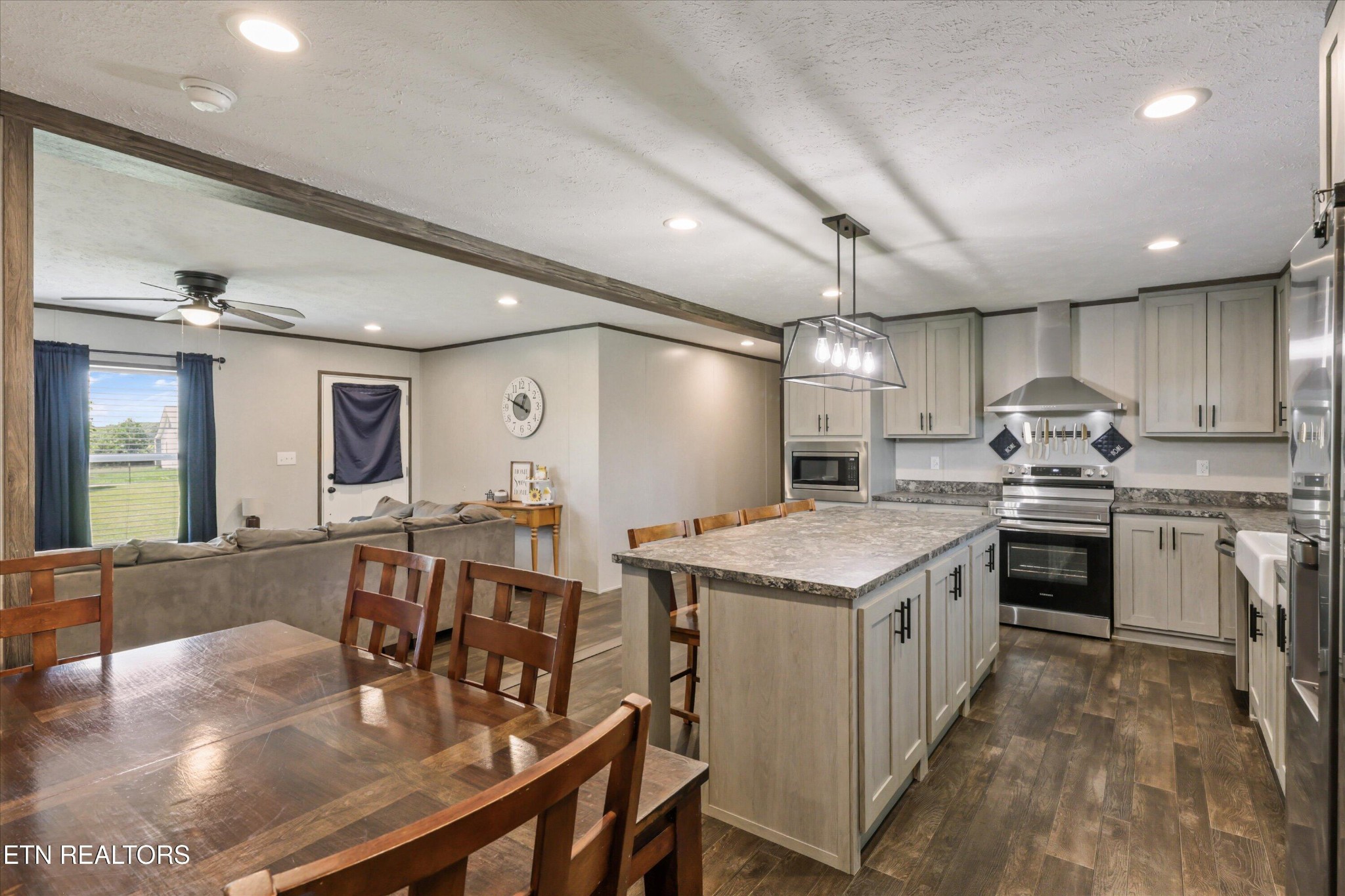 158 Frankfort Road Lancing, TN 37770 - Photo 16 of 46 a kitchen that has a lot of cabinets a sink a stove and wooden floors