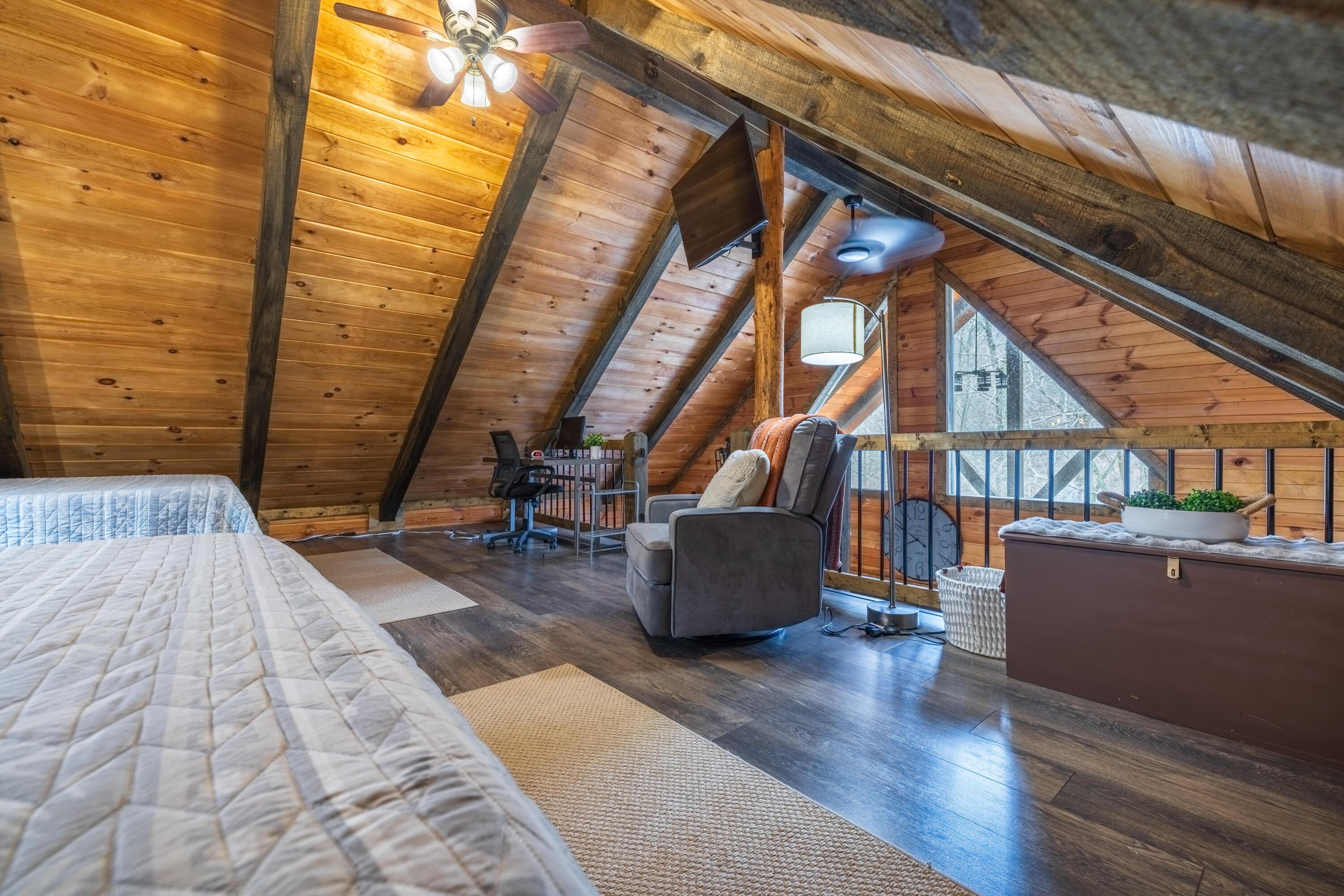 344 Skaggs Road Londonderry, OH 45647 - Photo 40 of 57 Sage Hill Cabin loft with 2 full beds, chair, and workspace