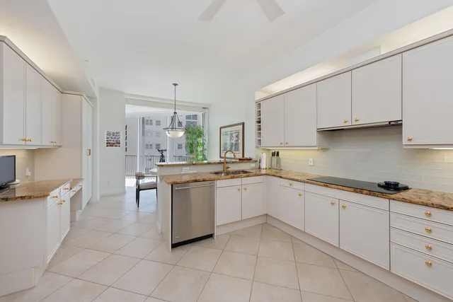 a kitchen with a sink window and cabinets