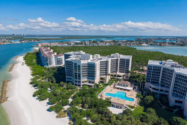 an aerial view of a house with a garden and mountain view
