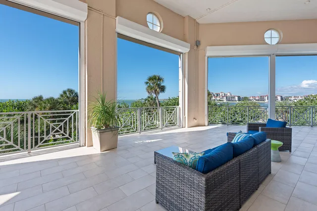 a living room with lots of furniture and chandelier