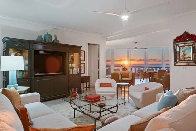 a living room with furniture a fireplace and a large window