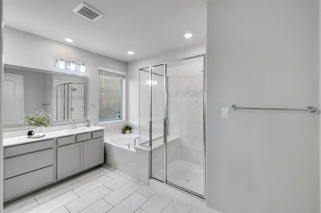a bathroom with a double vanity sink mirror and shower