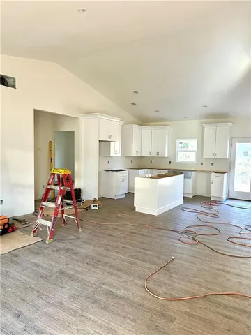 a living room with furniture and kitchen view
