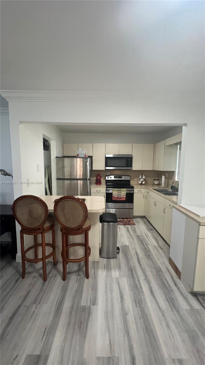 11920 Southwest 191st Terrace Miami, FL 33177 - Photo 3 of 10 a kitchen with stainless steel appliances a stove a sink a dining table and chairs