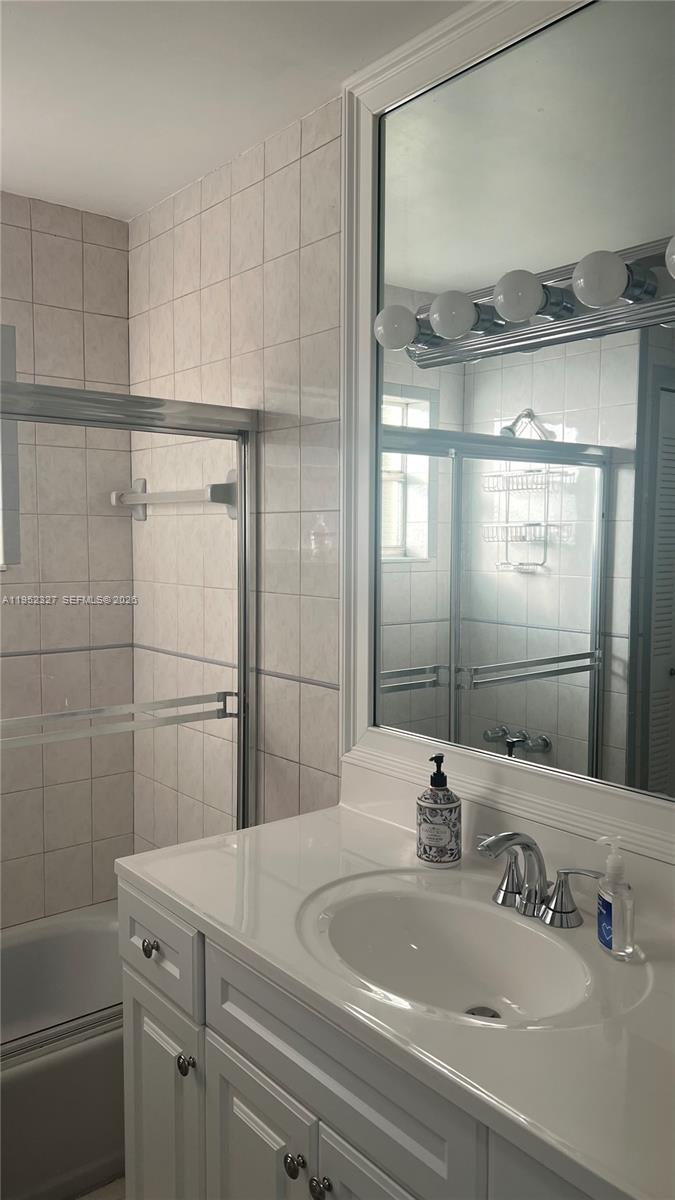 11920 Southwest 191st Terrace Miami, FL 33177 - Photo 4 of 10 a bathroom with a sink and a mirror
