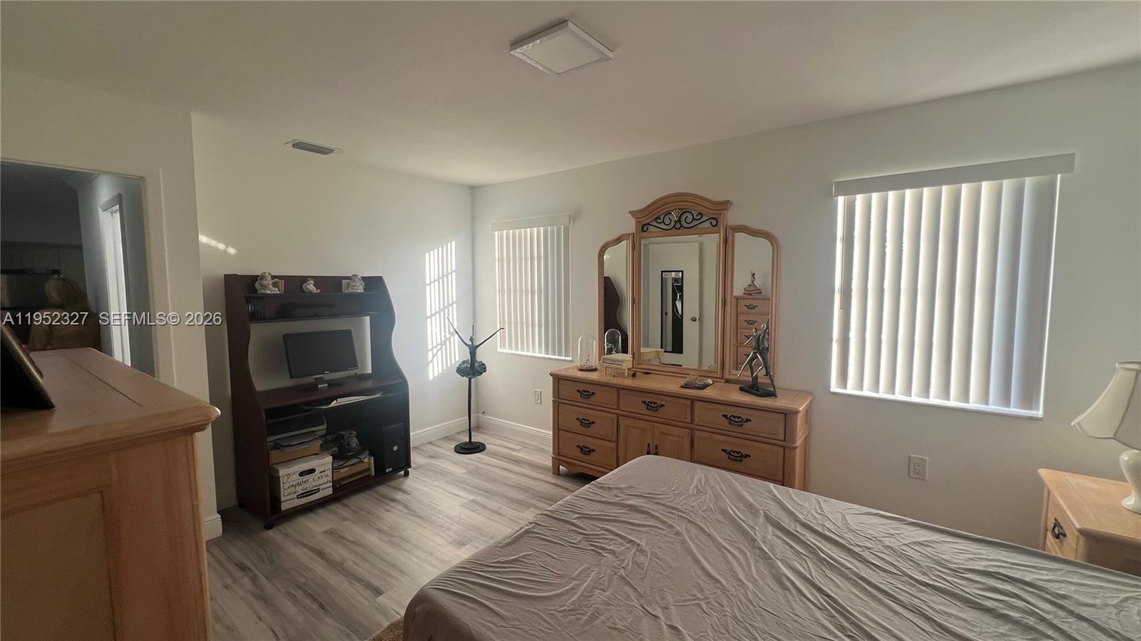 11920 Southwest 191st Terrace Miami, FL 33177 - Photo 6 of 10 a bedroom with a bed a television and dresser