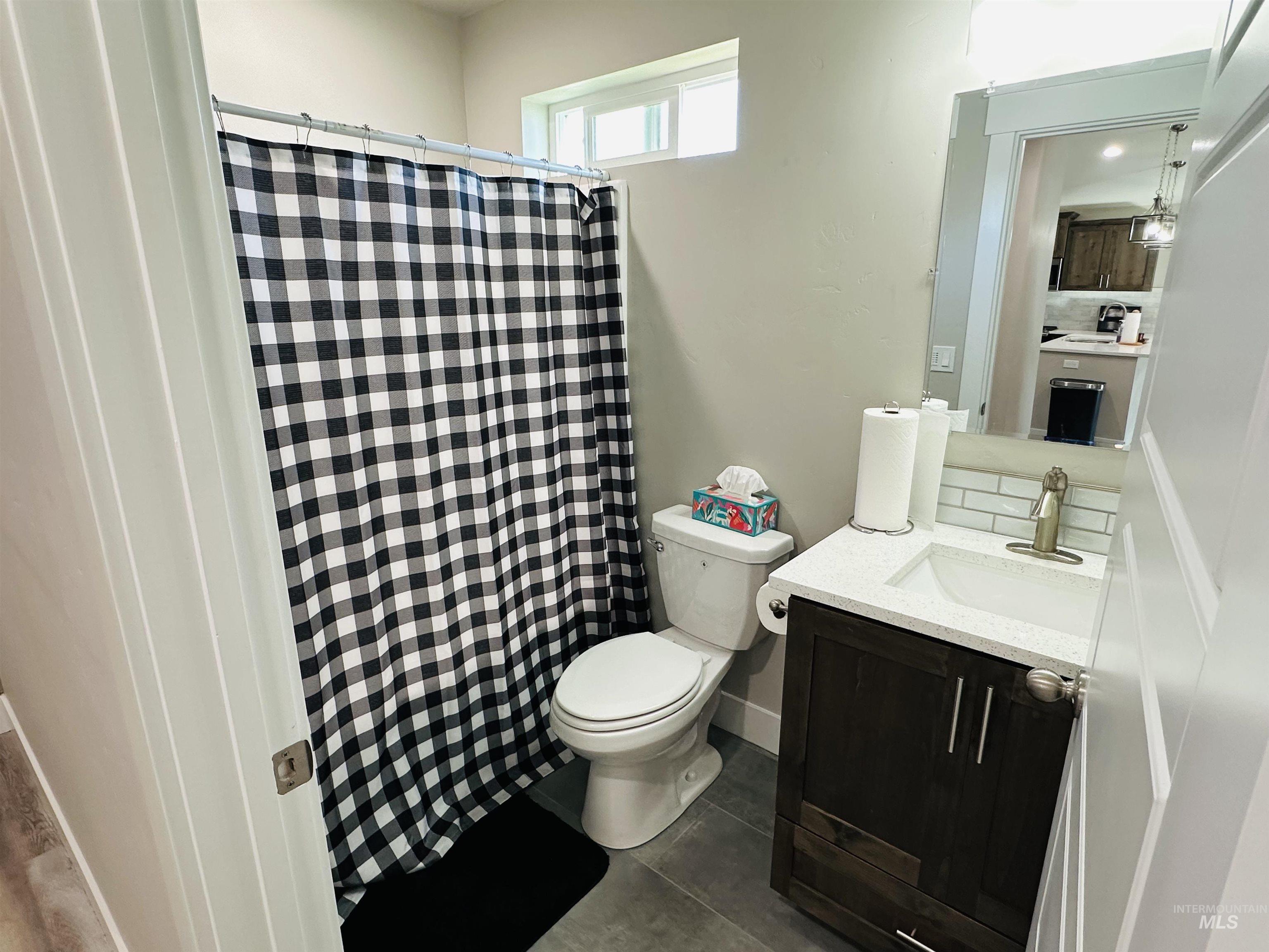 911 Campbell Street Vale, OR 97918 - Photo 21 of 37 Bathroom with vanity, a shower with shower curtain, and dark tile patterned floors