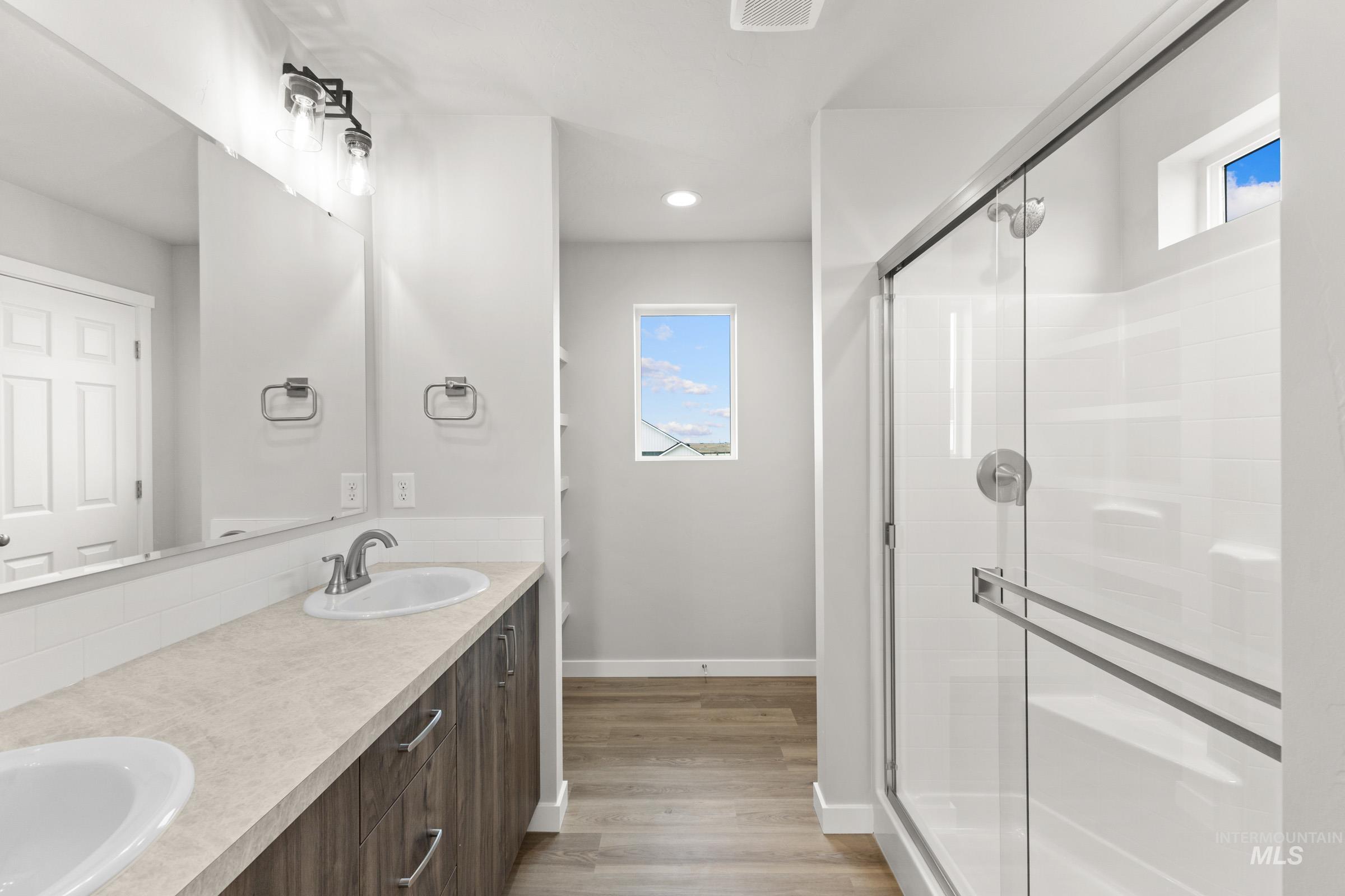 461 Waverly Avenue Middleton, ID 83644 - Photo 20 of 22 Bathroom with a shower stall, double vanity, light wood-style flooring, and recessed lighting