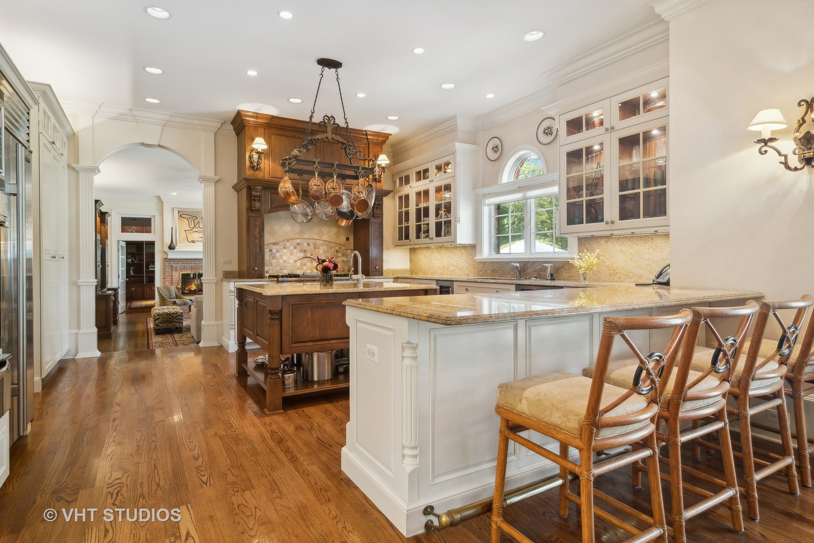 240 Donlea Road Barrington Hills, IL 60010 - Photo 14 of 63 a kitchen with kitchen island granite countertop wooden floors and a view of living room