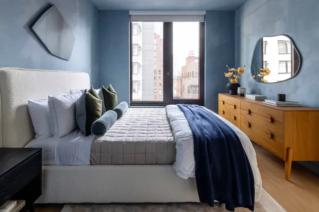 a bedroom with a large bed and a large window