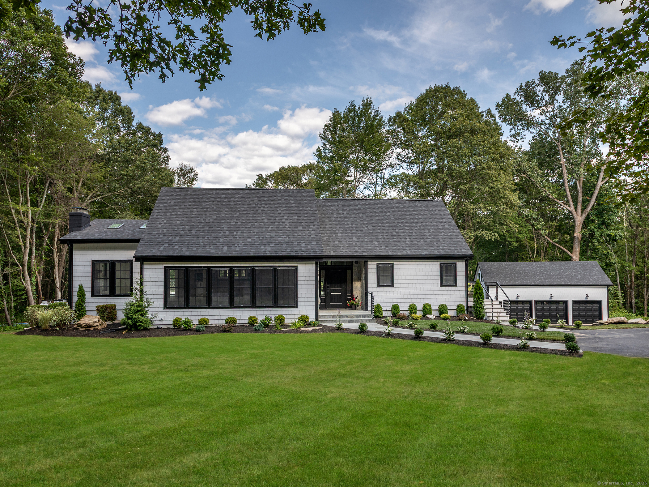 a front view of house with yard and outdoor seating