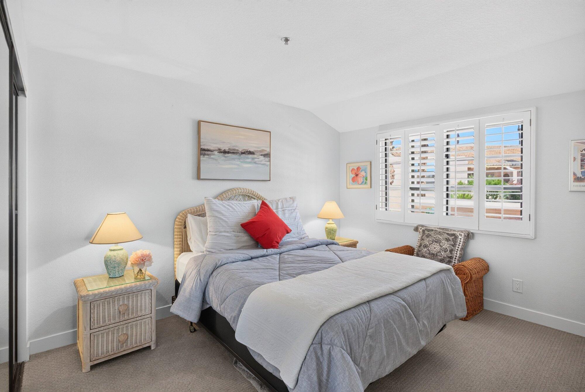 500 East Amado Road, Unit 313 Palm Springs, CA 92262 - Photo 15 of 32 a bedroom with bed and window