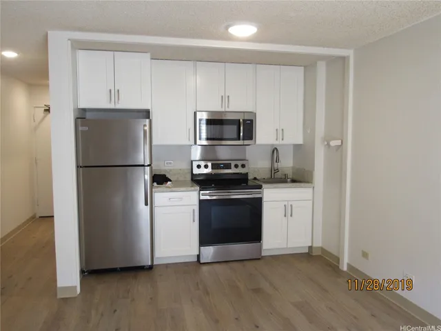 a kitchen with a refrigerator stove and microwave