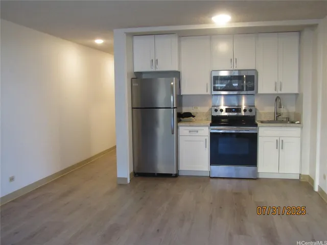 a kitchen with stainless steel appliances granite countertop a refrigerator stove a sink and dishwasher