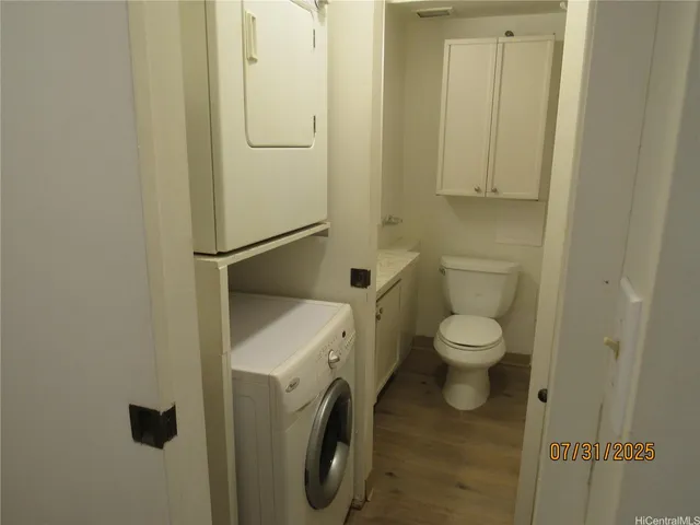 a white toilet sitting next to a bathroom sink