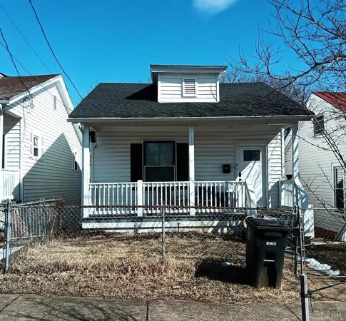 a front view of a house with iron fence