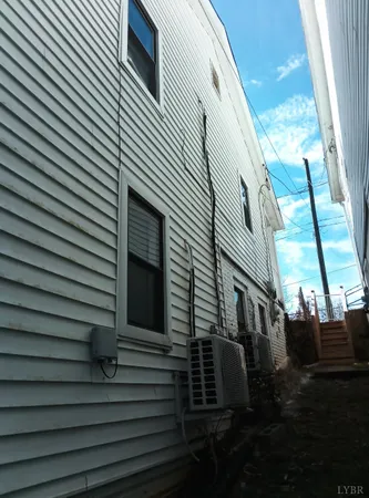 a view of a house with a door and a yard