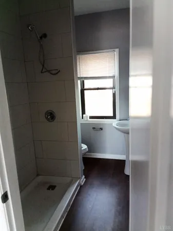 a bathroom with a shower and mirror