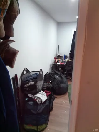 a living room with furniture and a mirror