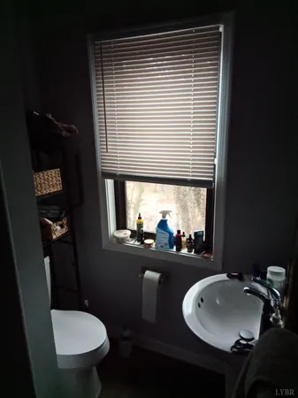 a bathroom with a toilet a sink and mirror