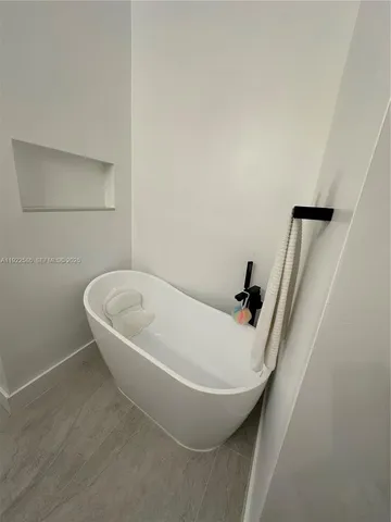 a white bath tub sitting in a bathroom