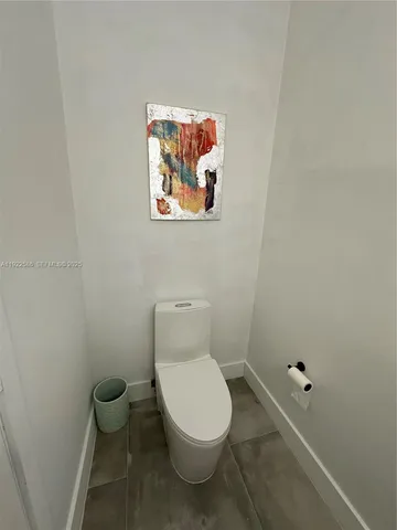 a white toilet sitting next to a white tub