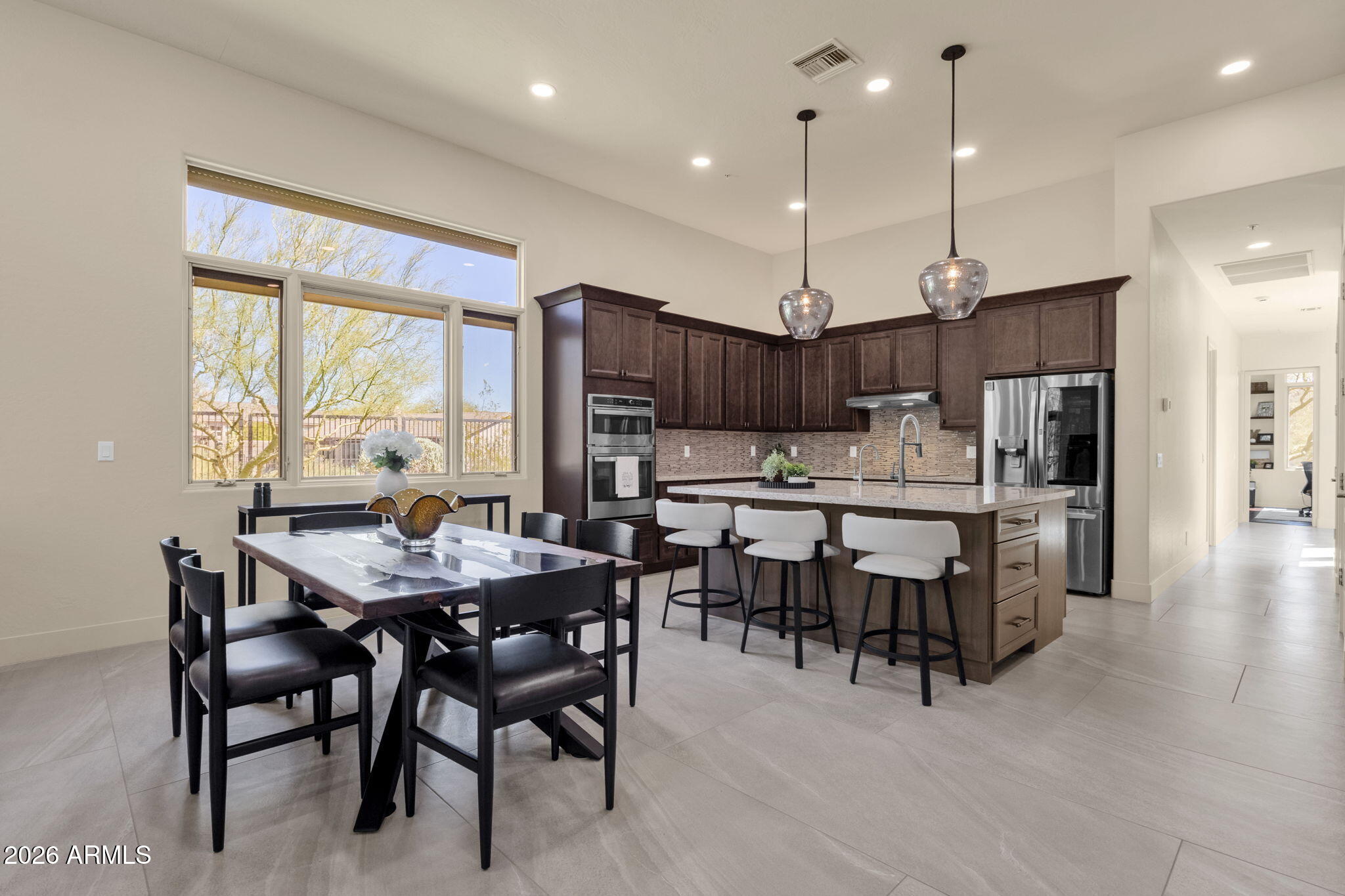 14402 East Wethersfield Road Scottsdale, AZ 85259 - Photo 10 of 57 a view of a dining room with furniture window and wooden floor