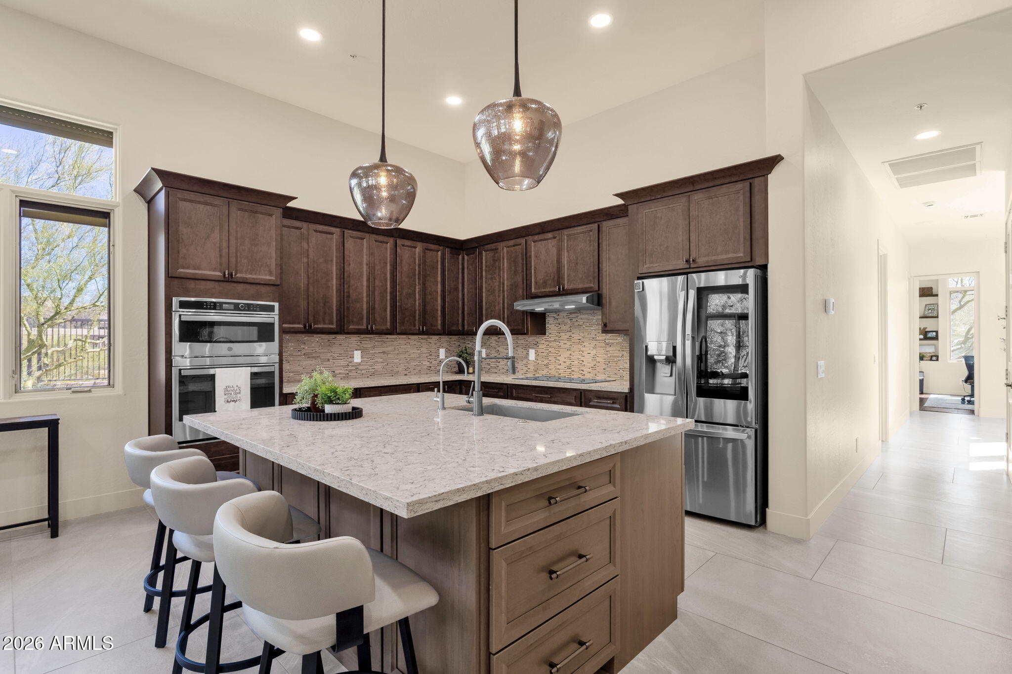 14402 East Wethersfield Road Scottsdale, AZ 85259 - Photo 11 of 57 a kitchen with cabinets appliances and a dining table