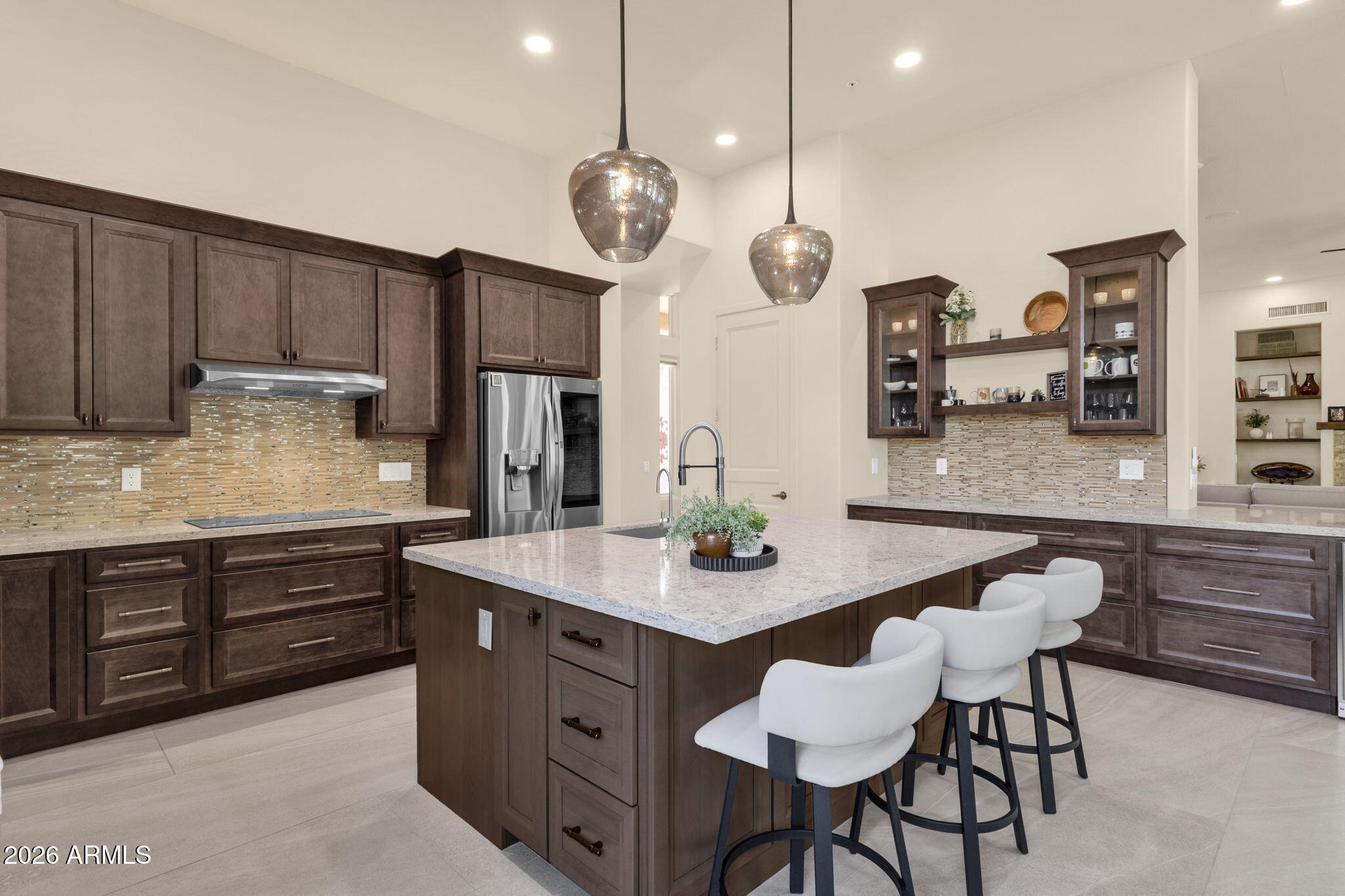 14402 East Wethersfield Road Scottsdale, AZ 85259 - Photo 12 of 57 a kitchen with cabinets a counter space dining table and stainless steel appliances