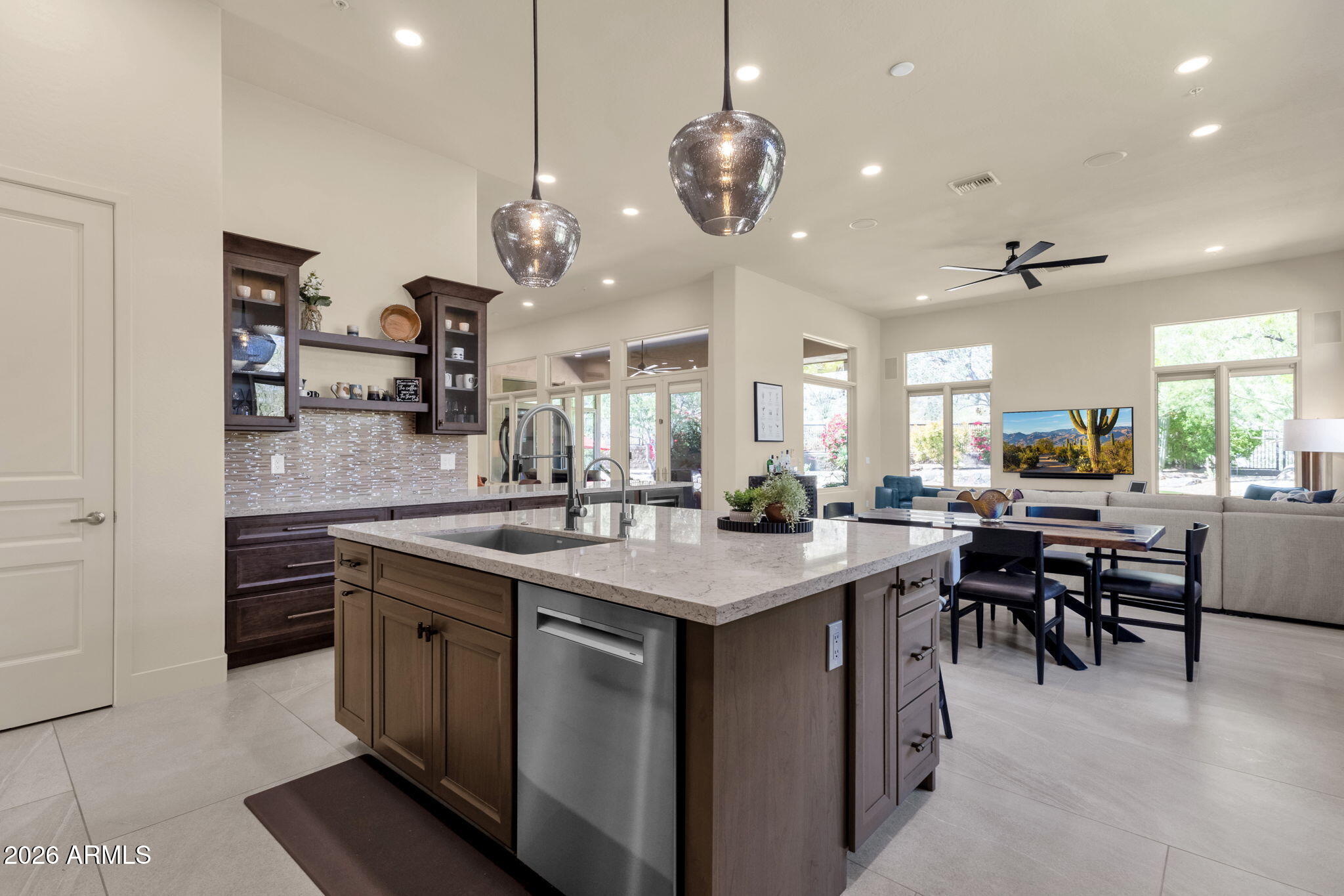 14402 East Wethersfield Road Scottsdale, AZ 85259 - Photo 13 of 57 a open kitchen with stainless steel appliances granite countertop a stove a sink a dining table and chairs