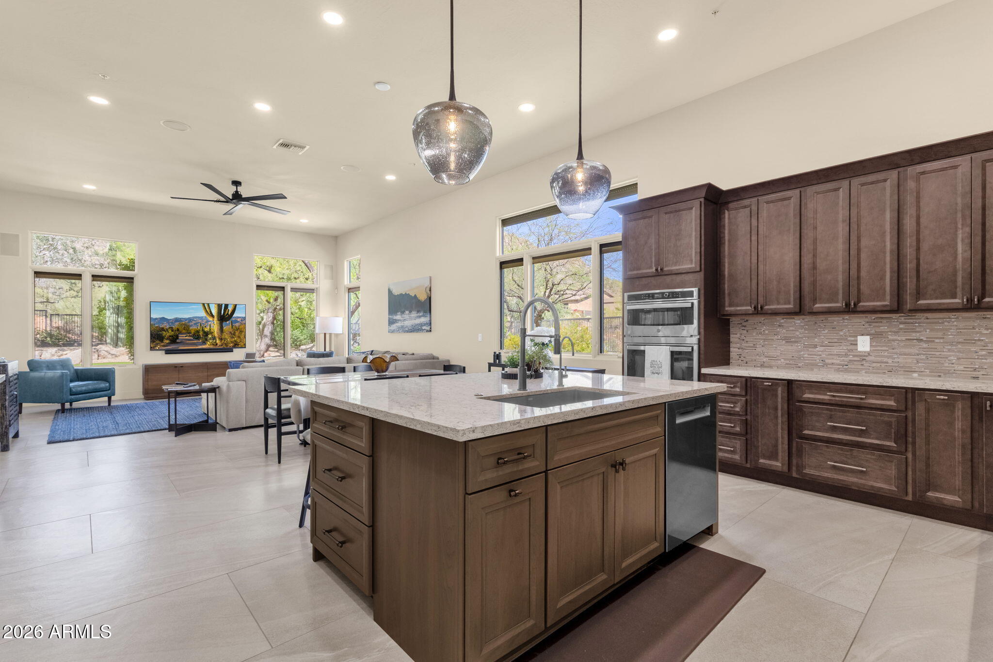 14402 East Wethersfield Road Scottsdale, AZ 85259 - Photo 14 of 57 a kitchen with a stove a sink a center island and a window