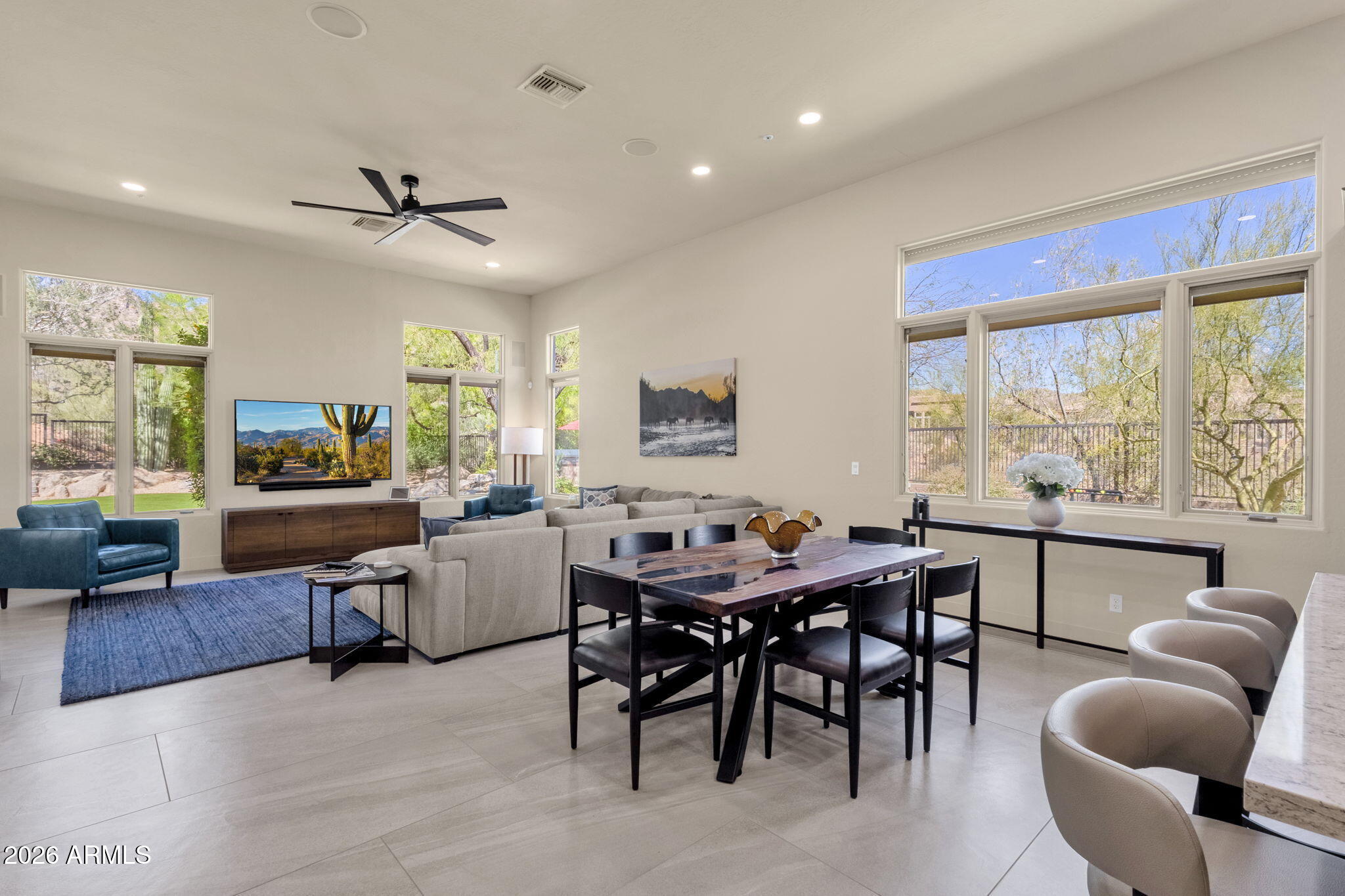 14402 East Wethersfield Road Scottsdale, AZ 85259 - Photo 16 of 57 a view of a dining room with furniture window and wooden floor