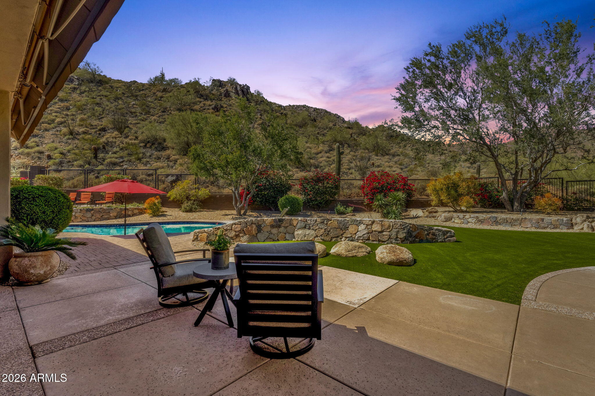 14402 East Wethersfield Road Scottsdale, AZ 85259 - Photo 2 of 57 a view of a patio with couches and table and chairs and potted plants