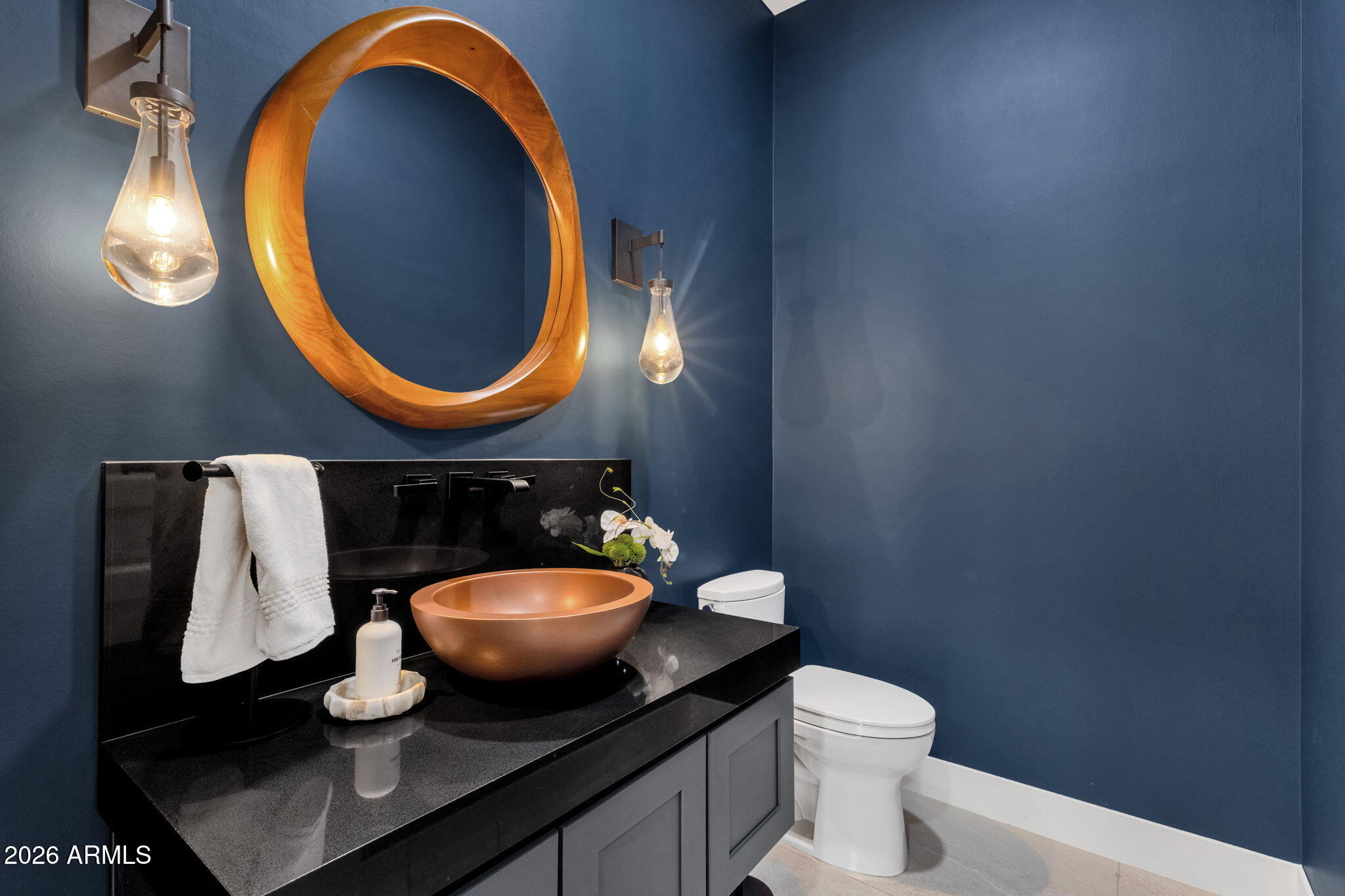 14402 East Wethersfield Road Scottsdale, AZ 85259 - Photo 29 of 57 a bathroom with a toilet a sink and a mirror