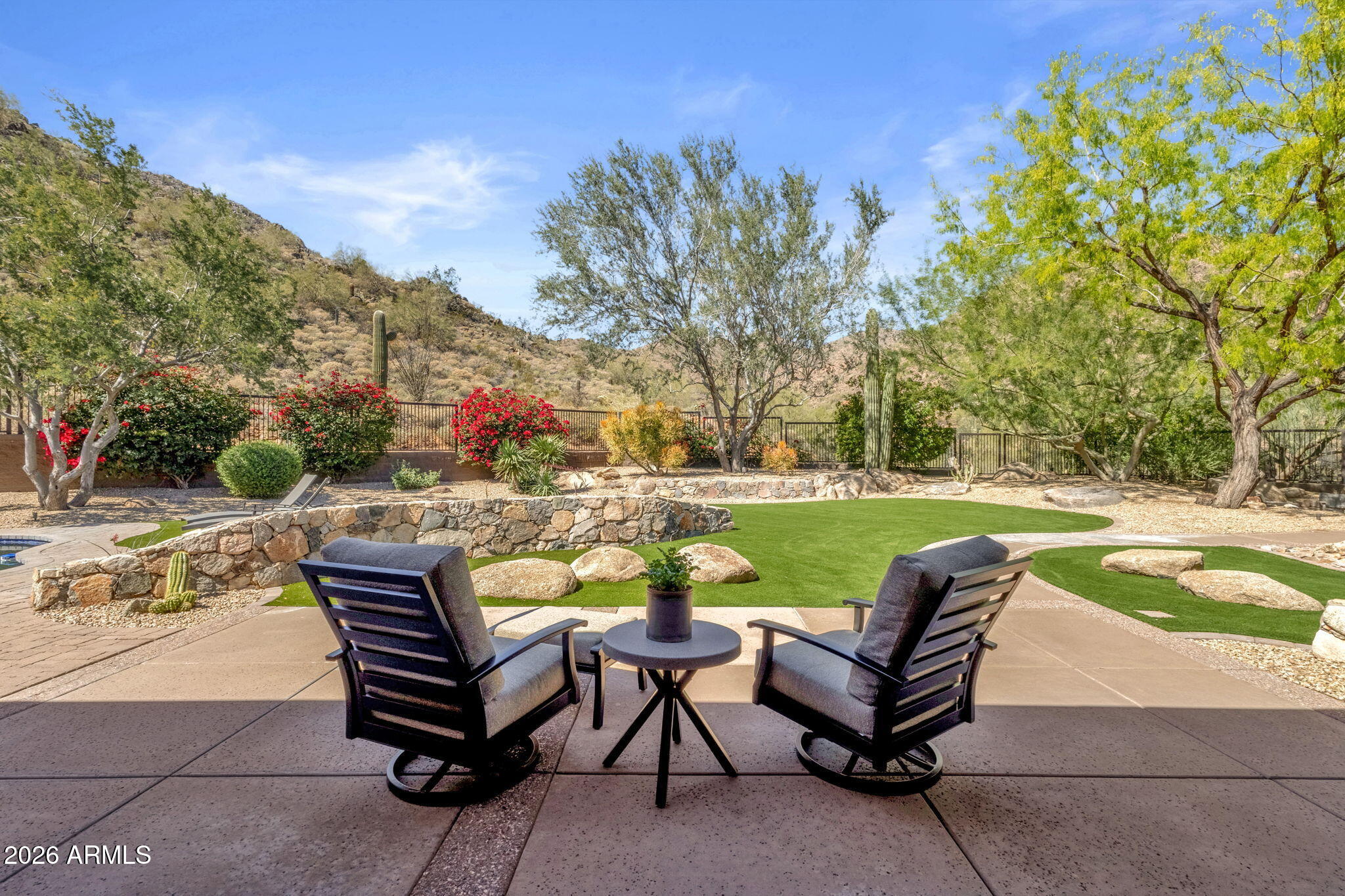 14402 East Wethersfield Road Scottsdale, AZ 85259 - Photo 37 of 57 a view of a swimming pool and lounge chairs