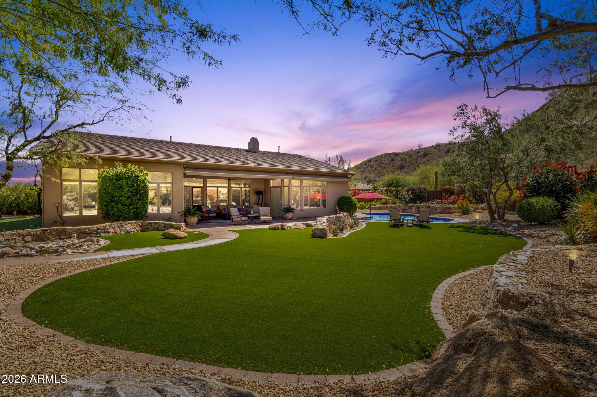 14402 East Wethersfield Road Scottsdale, AZ 85259 - Photo 3 of 57 a view of a house with a swimming pool and a yard