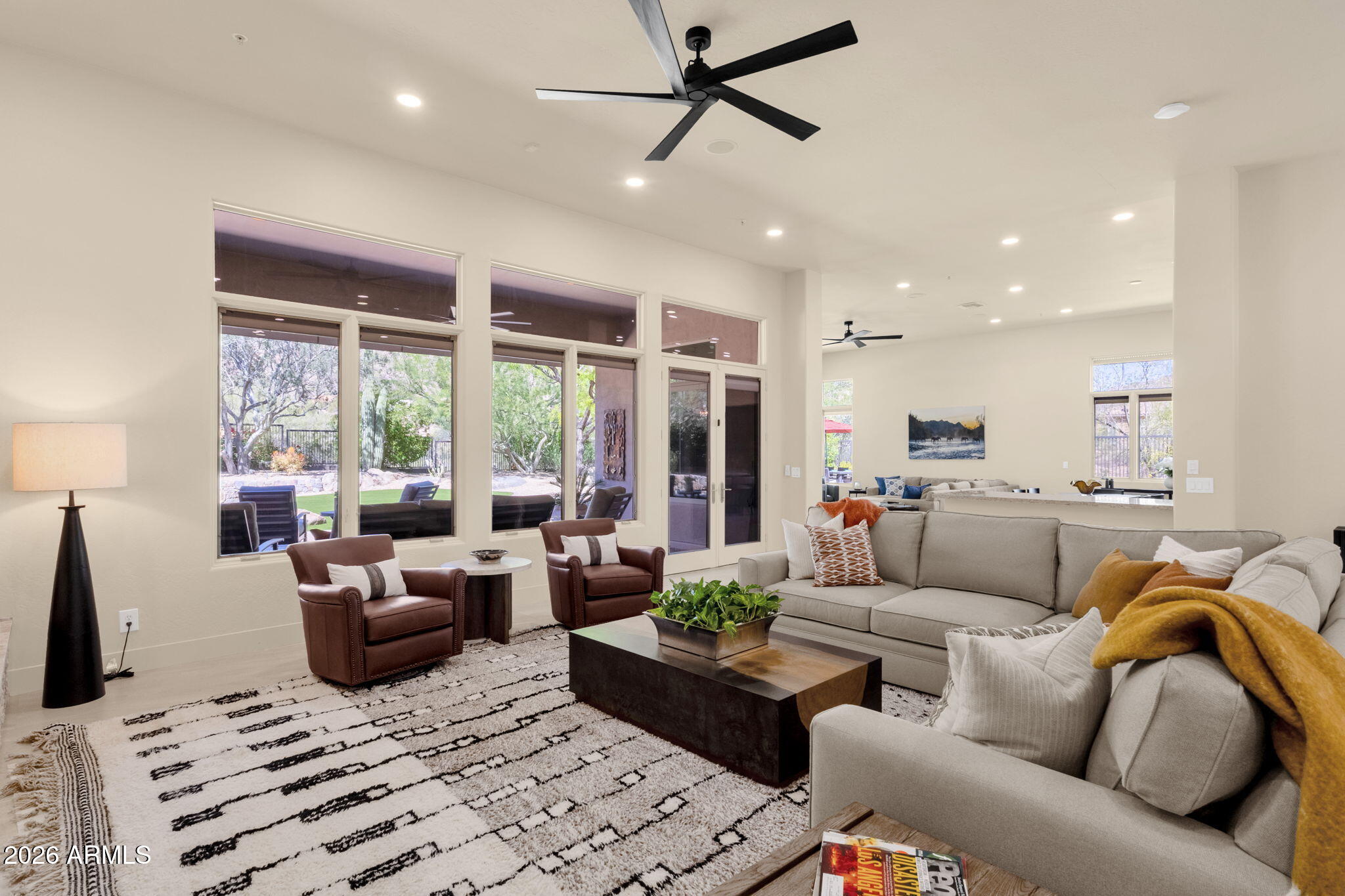 14402 East Wethersfield Road Scottsdale, AZ 85259 - Photo 7 of 57 a living room with furniture ceiling fan and a rug