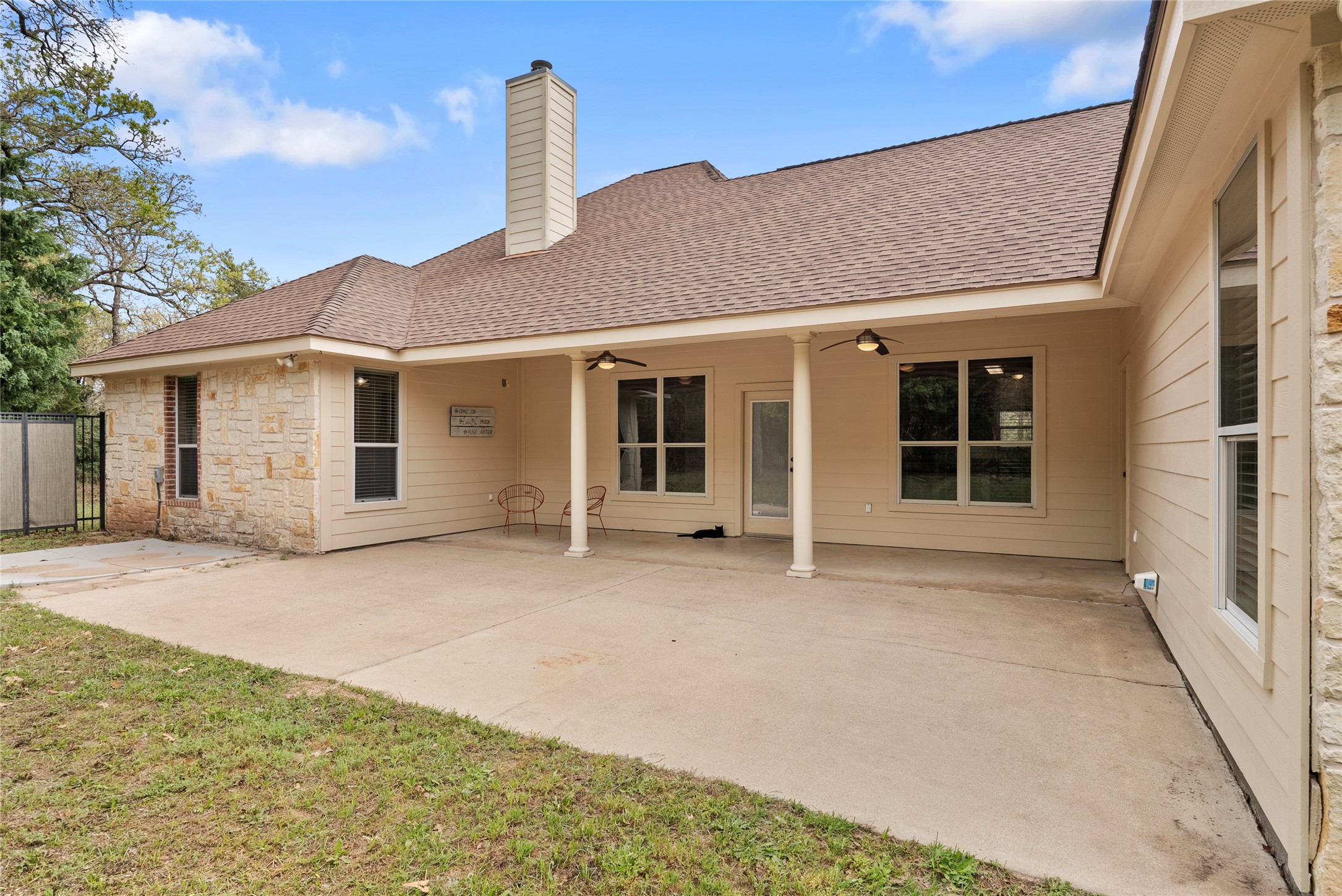 330 Arbors Circle Elgin, TX 78621 - Photo 32 of 37 Rear view of property featuring a patio area, roof with shingles, a ceiling fan, a chimney, and fence