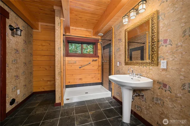 an empty room with windows and ceiling fan